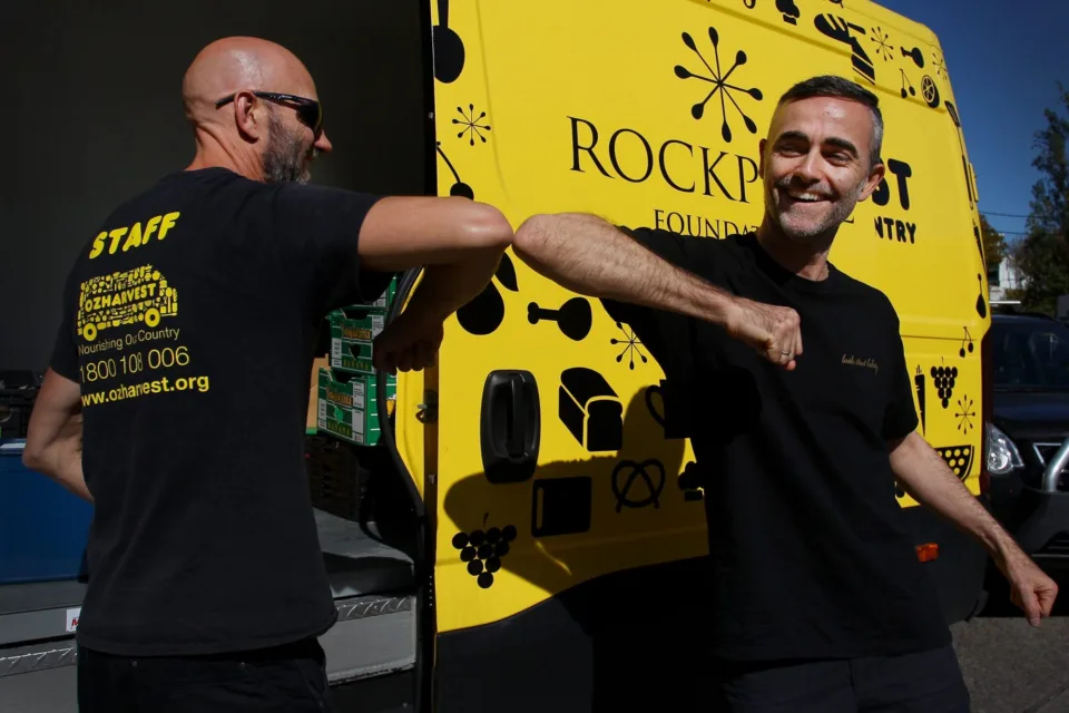 OzHarvest food rescue driver interacting with a charity partner.