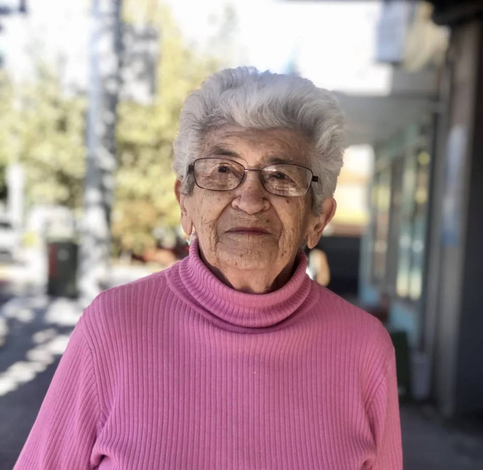 Yvonne, elderly OzHarvest Market customer, wearing a pink sweater
