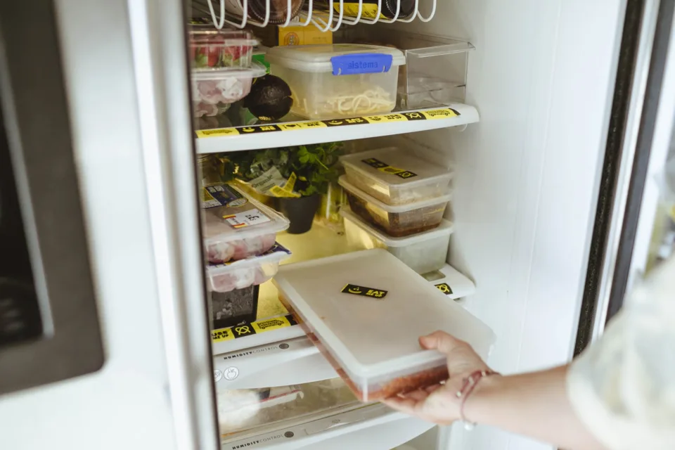 Full fridge with containers with the Use It Up tape on them