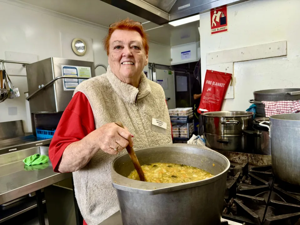 OzHarvest charity partner preparing a meal for people in need.