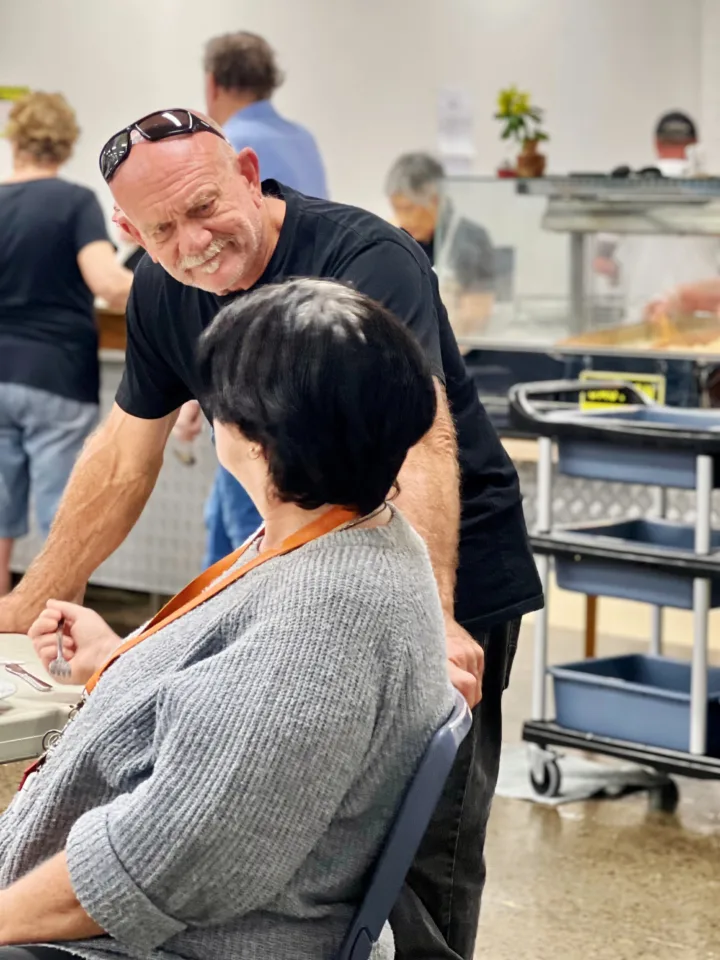 OzHarvest charity partner speaking to a person in need.